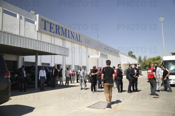 Officials from the Qatari and Syrian Red Crescents receive a Qatari airlift of aid to help the