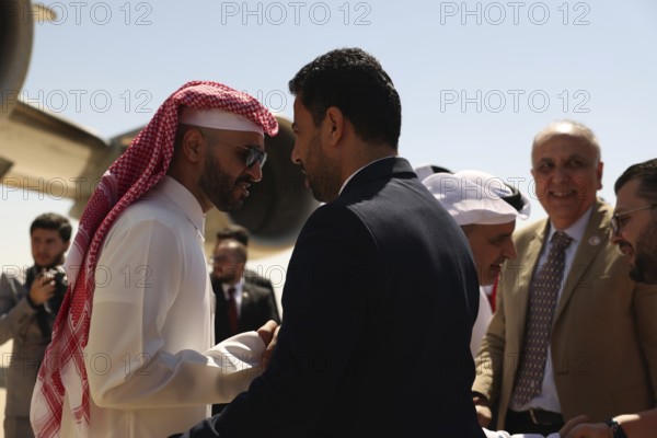 Syrian Health Minister Musab al-Omar welcomes a Qatari aircraft loaded with medical and