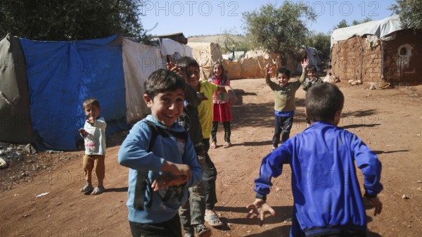 Syrian children playing in a refugee camp near the Turkish border on World Children's Day. Aleppo,