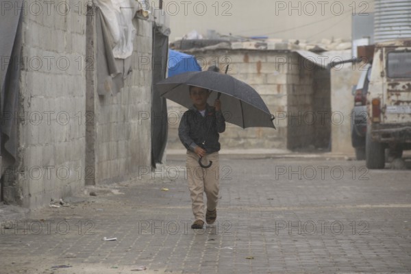 Syrian children playing in a refugee camp near the Turkish border on World Children's Day. Aleppo,