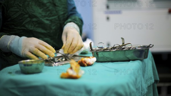 Several doctors performing a complex surgical operation inside an operating room for a displaced