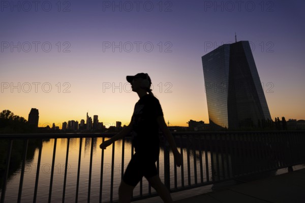 The sun sets behind the European Central Bank (ECB) and the Frankfurt banking skyline, Frankfurt am