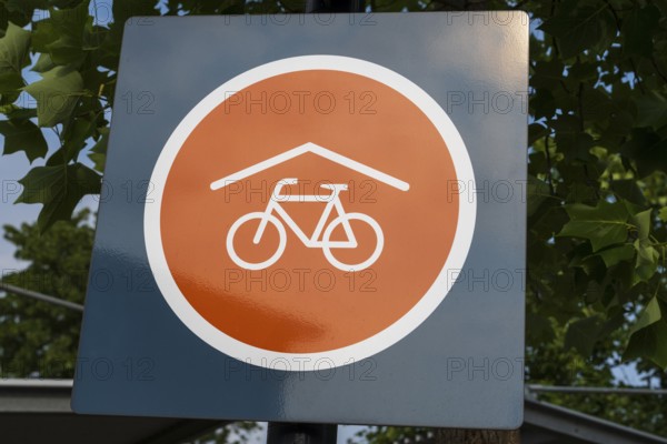 Covered bicycle parking space, sign with logo, Rheda-Wiedenbrück, Westphalia, North