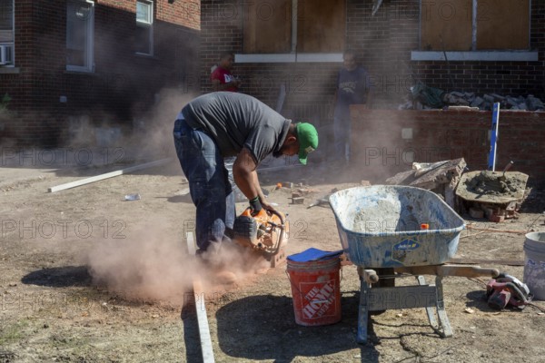 Detroit, Michigan - Workers rebuild the front porch of a house they are remodeling in the