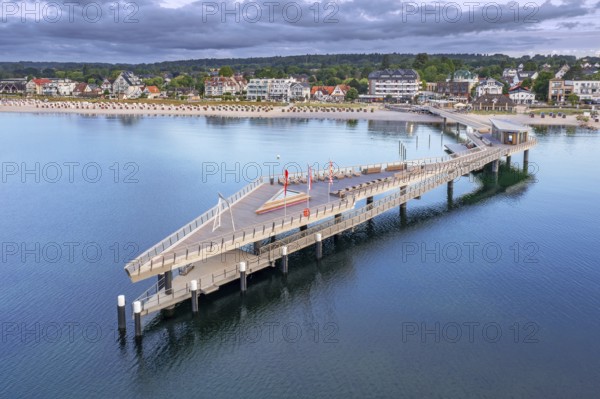 Aerial view over Seebrücke, pier and sandy beach at seaside resort Haffkrug along the Baltic Sea,