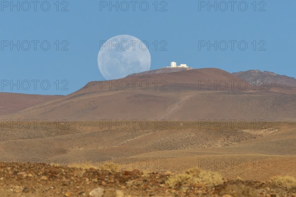 An observatory on a mountain next to the rising full moon, San Pedro de Atacama, San Pedro de