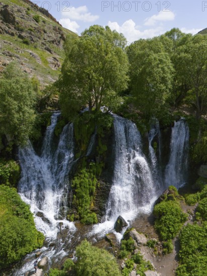 Large waterfall in mountainous surroundings with lush vegetation, aerial view, Shaki waterfall,