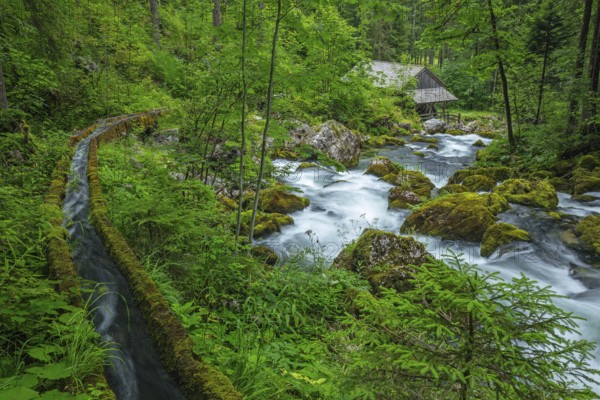 Golling watermill from above at the waterfall with the water pipe. Traditional mill in an alpine