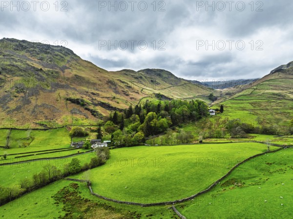 Farms and Mountains over road A591 from a drone, Grasmere Lake, Grasmere, Ambleside, Lake District,