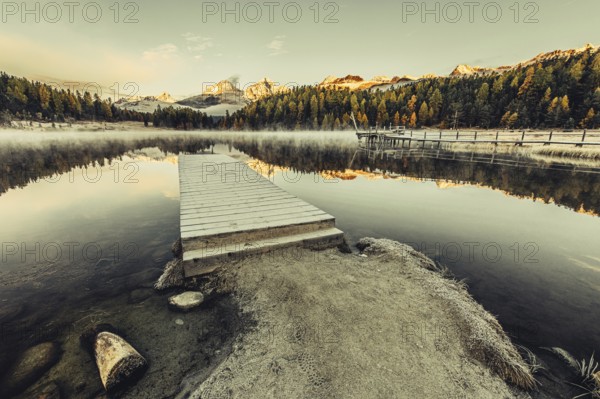 Lake Staz near Sankt Moritz in the Engadin in Switzerland. Morning atmosphere with fog in autumn.