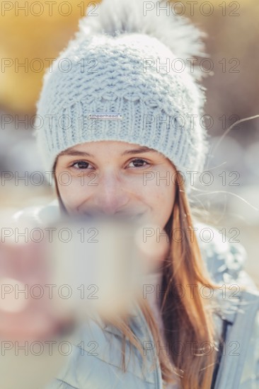 Woman in winter clothes in autumn Engadine with golden trees in Switzerland