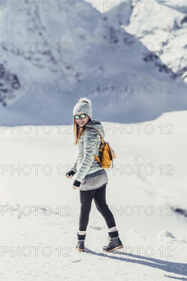 Woman in wintry surroundings in the Engadine in Switzerland