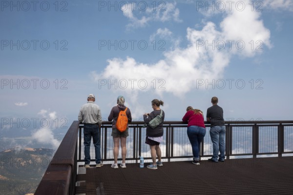 Colorado Springs, Colorado - Tourists line a viewint platform at the summit of Pikes Peak, a 14,