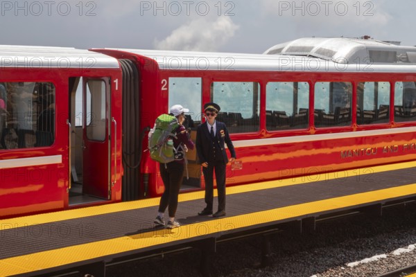 Colorado Springs, Colorado - A conductor talks with a passenger after the Manitou and Pikes Peak