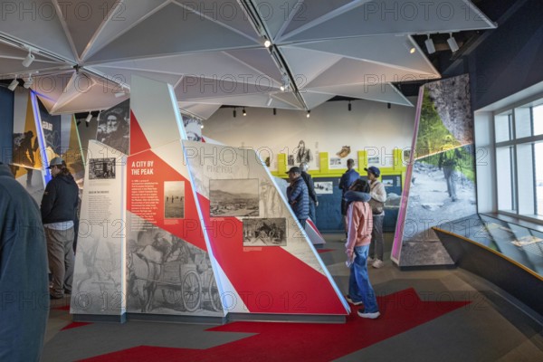 Colorado Springs, Colorado - Tourists view displays in the Summit Visitor Center at Pikes Peak, a