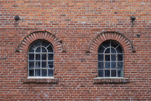 Old windows in a traditional brick wall with rustic charm and visible reflections, Stiftsmühle,