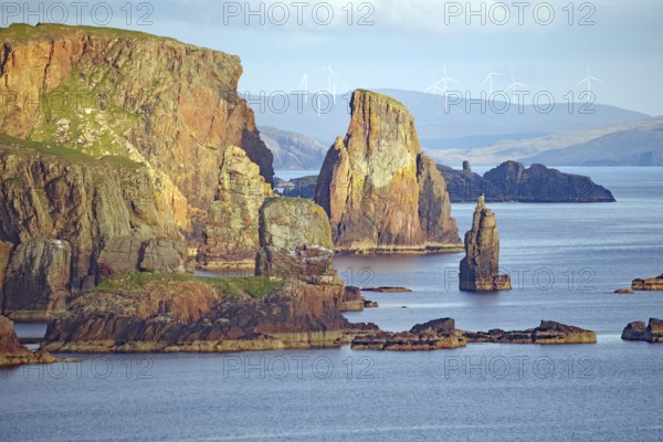 Dramatic coastal landscape with high cliffs, wind turbines and calm sea, Eshaness, Shetland