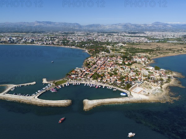 Aerial view of a coastal town with boat harbour. Mediterranean houses and blue sea, aerial view,