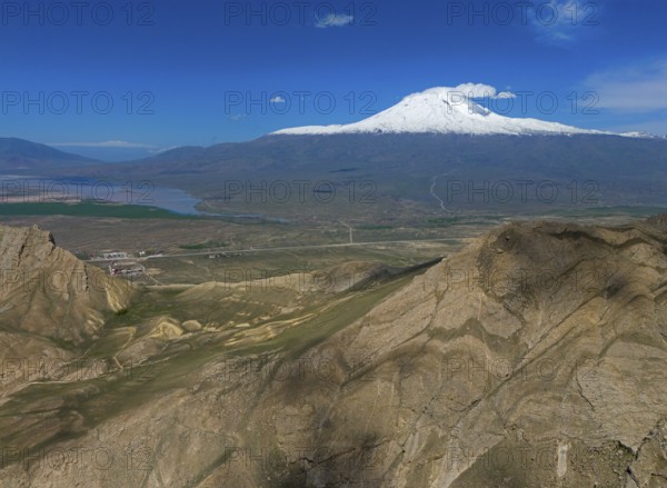 Snow-covered mountain under a clear blue sky with a vast landscape in the foreground, Great Ararat,