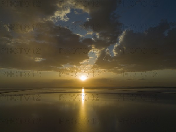 A calm sunset over a lake with golden coloured sky and clouds, aerial view, salt lake, Tuz Gölü,