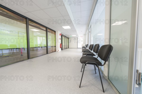 Modern, bright hallway with chairs and glass doors in the waiting area, Care Connect, vaccination