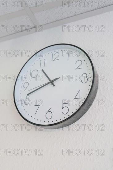 Round wall clock with white dial and black hands, Care Connect, vaccination kiosk for refugees,