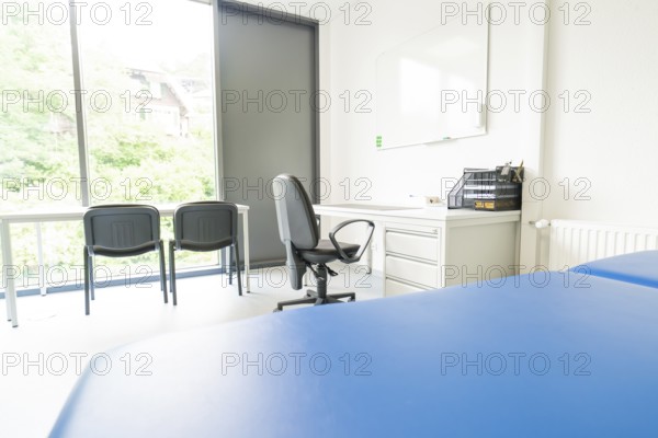 Bright office space with desk and chairs in front of large windows, Care Connect, vaccination kiosk