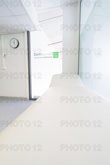 Treatment room with couch and CareConnect logo in minimalist style, Care Connect, vaccination kiosk