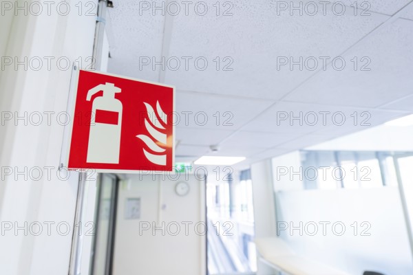Safety sign for fire extinguisher installed in an office corridor, Care Connect, vaccination kiosk
