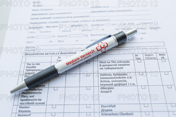 Biros lying on a medical form on a desk, Care Connect, vaccination kiosk for refugees, Calw,
