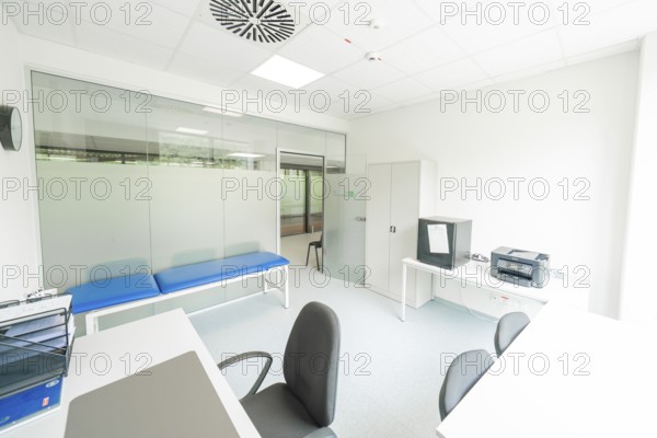 A bright examination room with couch and desk, Care Connect, vaccination kiosk for refugees, Calw,