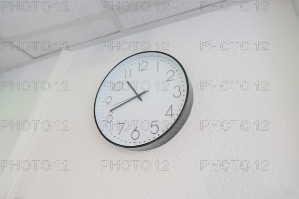 Plain white wall clock with black hands on the wall, Care Connect, vaccination kiosk for refugees,