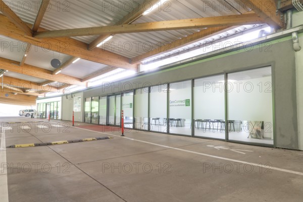 Modern building with glass front and car park at CareConnect, Care Connect, vaccination kiosk for