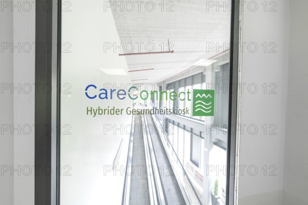 Bright escalator with CareConnect logo in a modern building, Care Connect, vaccination kiosk for
