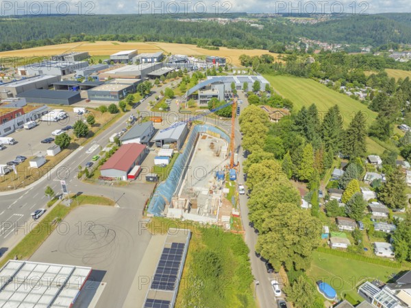 Aerial view of a construction site in a rural industrial landscape, car park construction, Calw,