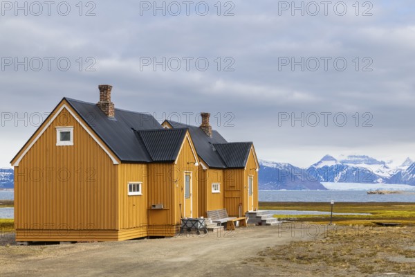 Wooden house against a mountain backdrop, Ny-Alesund, Spitsbergen, Svalbard