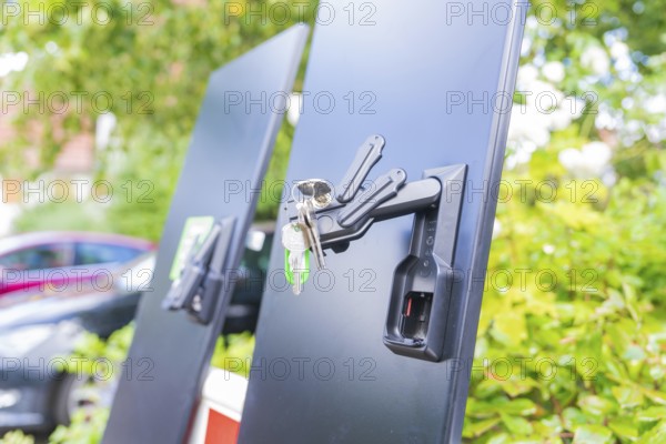 Black panels with a bunch of keys on a lock, installation of a charging station for electric cars,