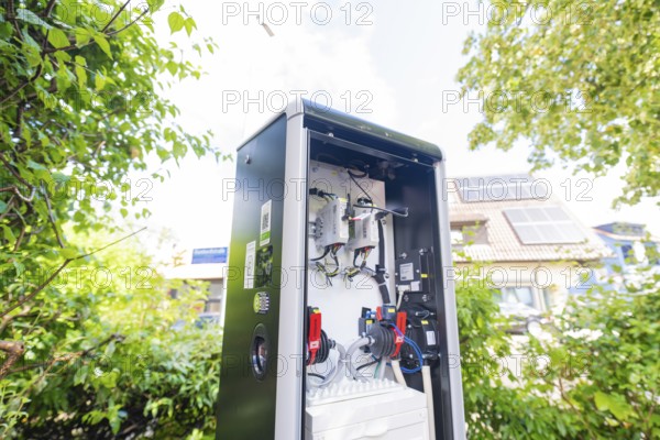 Open outdoor electrical system between trees with solar system in the background, installation of a