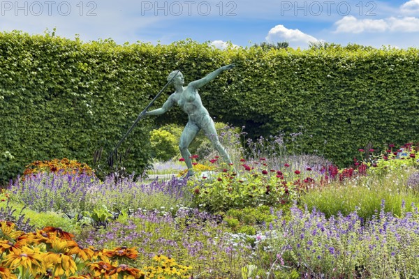 Sculpture Statue of bronze javelin thrower from 1937 by sculptor and artist Ernst Seger in flower