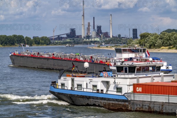 Industrial backdrop of the ThyssenKrupp Steel steelworks in Duisburg-Bruckhausen, cargo ships on