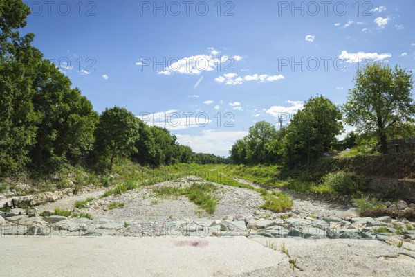 Extensive dry riverbed of the Schwarza with vegetation and surrounding nature, Neunkirchen, Lower