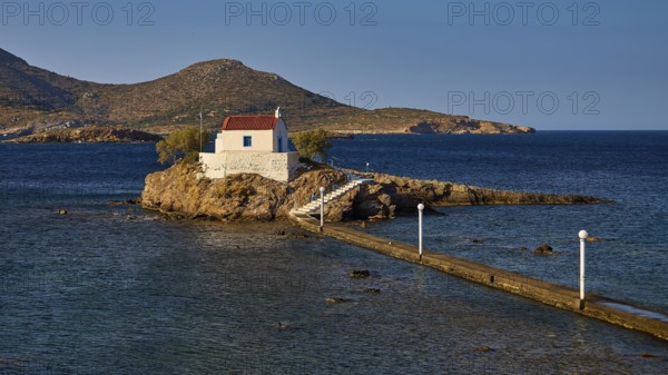 Quiet, peaceful coastal scene with chapel on rocky island, surrounded by blue water, chapel,