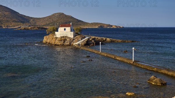 Calm scene with chapel on rocks in the sea under morning light, chapel, church, Agios Isidoros,