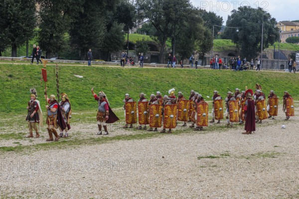 Traditional group Roman legionaries soldiers in line up with large shield and swords next to