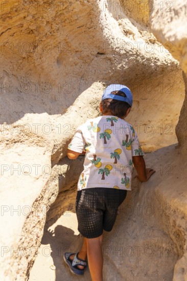 Young adventurer discovering extraordinary sandstone formations in drumheller, canada, while