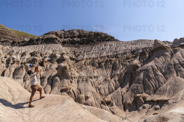 Tourist father is lifting his son in the air in the otherworldly landscape of the canadian