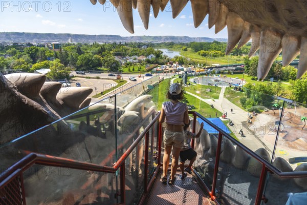 Mother and son enjoying a panoramic view of drumheller from inside the world's largest dinosaur, a