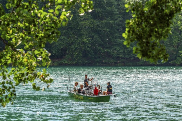Manually operated ferry with ferryman and passengers, Lake Schmaler Luzin, Feldberg Lake District,