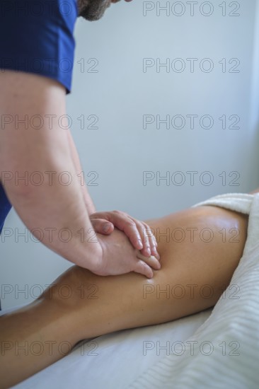 A skilled therapist performs a soothing leg and thigh massage using oil, promoting relaxation and