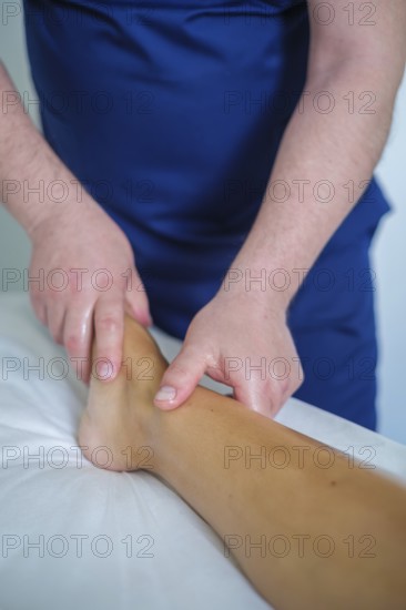A woman enjoys a soothing foot and leg massage at a spa, where an expert therapist uses oil for